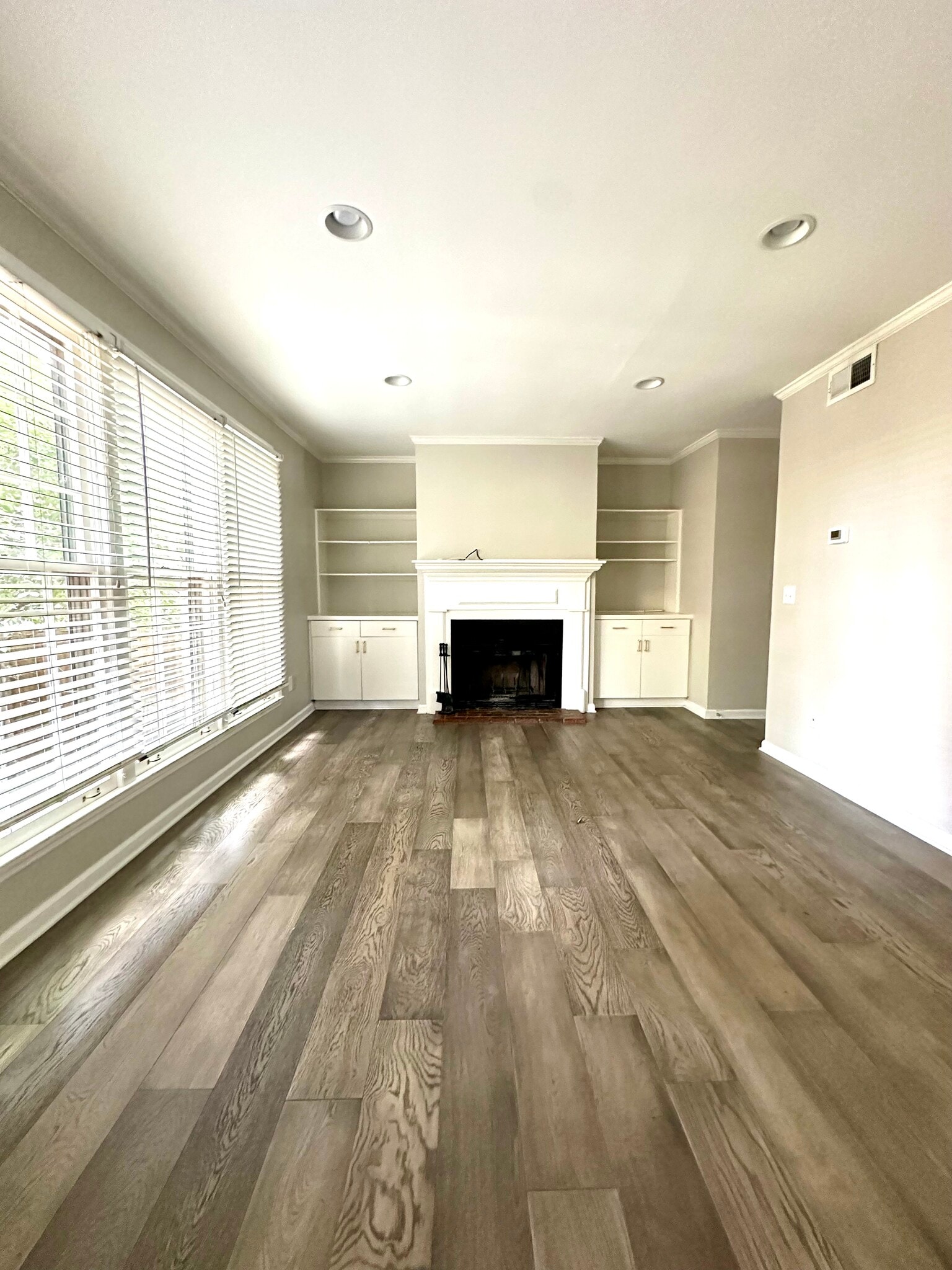 Light-filled living room, built-in shelving and cabinets, mantel is TV ready - 2312 18th Ave S