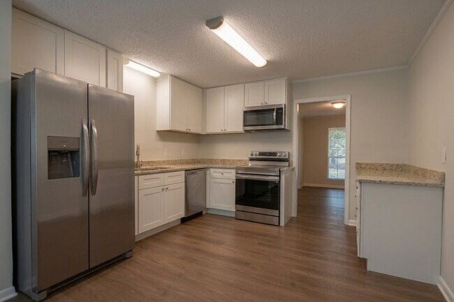 Building Photo - Fully Renovated 3BR/2BA Molino Home on a Spacious Lot Featuring Multiple Living Areas, Sunroom & ...