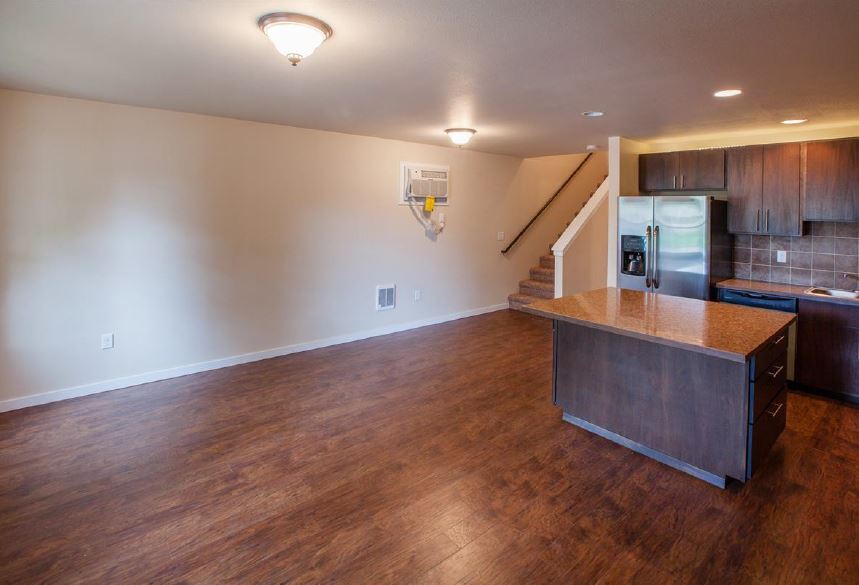 Another view of kitchen/family area showing stairs leading up to master suite. - 1220 W Bismark Ave