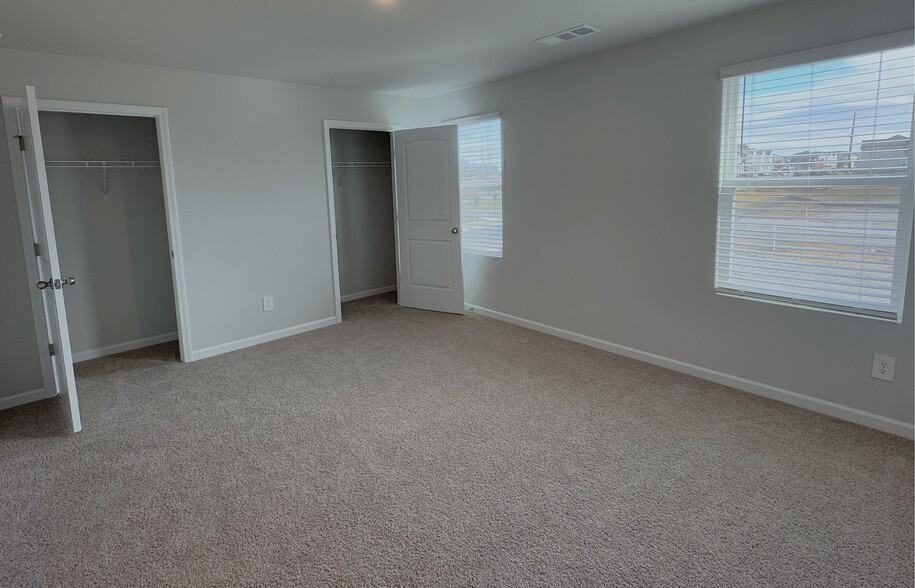 The upstairs master bedroom has two closets and an en-suite bathroom. - 403 Augustine Dr