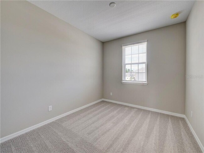 Bed room #2 (total 3 bedroom) fits a queen or full bed with windows and high quality durable carpet. - 1074 Amber Leaf Trail