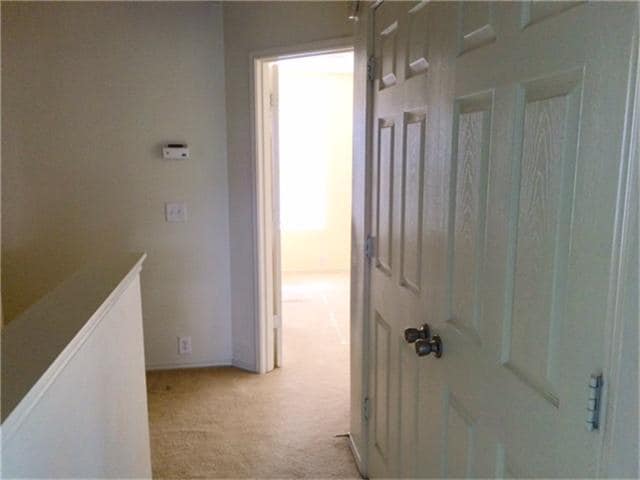 Heading down hallway to other master bedroom. - 23619 Twisting Falls Drive