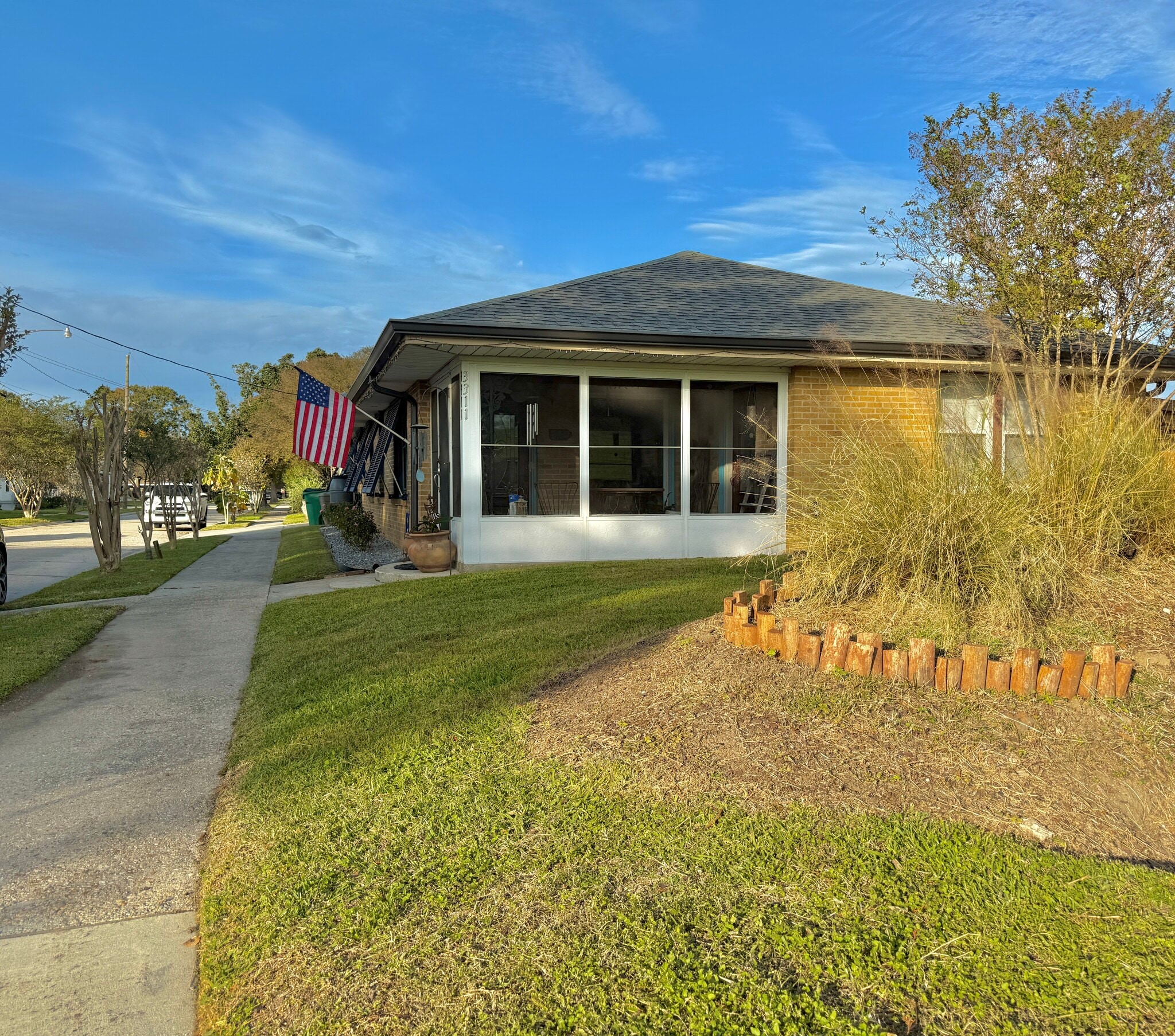 Screened in porch faces the levee - 3311 River Rd