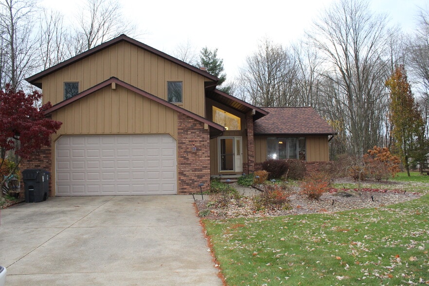 Charming split-level home with brick-and-wood exterior, attached two-car garage, and great curb appe - 6235 Sunnywood Dr