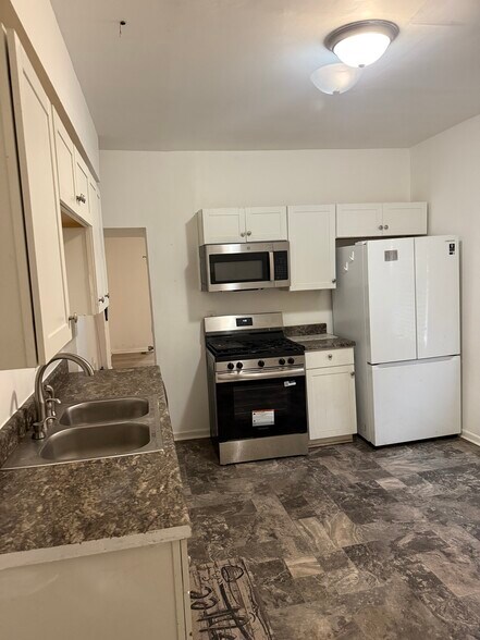 Kitchen less than a year old dish washer, stove, and washer/dryer - 672 Stewart Ave