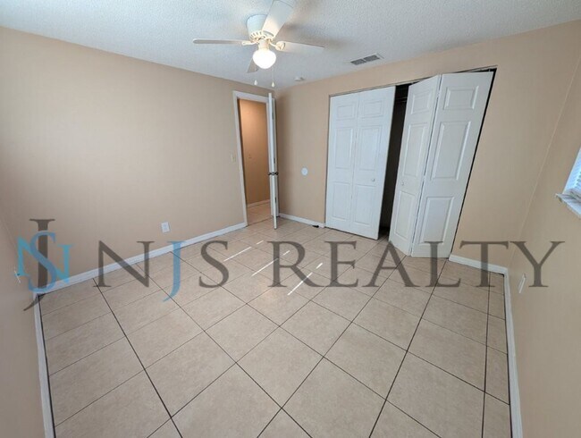 Building Photo - This 3/2/1 with over 1100 sq ft offers all tile floors open kitchen/dining, split floor plan on a...