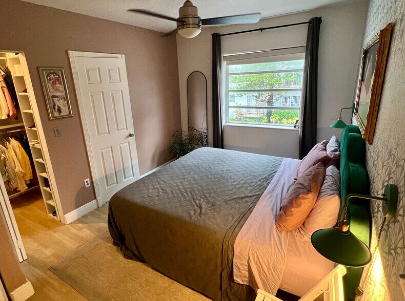 King bed in bedroom with lots of natural light with bathroom door - 901 Euclid Ave
