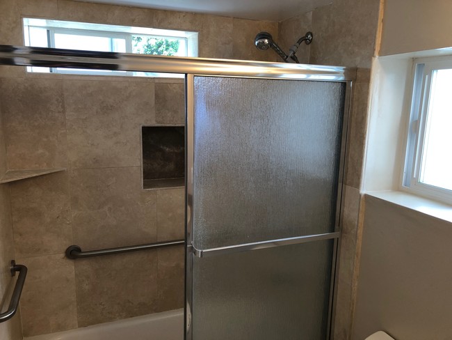 travertine tile in bathroom - 2118 Ernest Ave