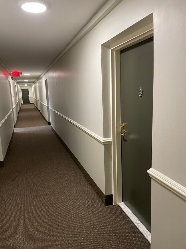 Looking at Unit #108's front door and hallway. - 4555 MacArthur Blvd NW