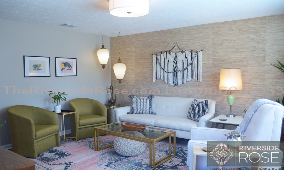 Living room with mid-century boho decor, local art, and high-end furnishings. - 3726 Moss Rose Dr