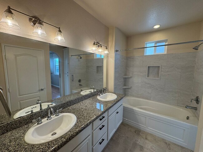 Building Photo - Sleek 2-Bed with a Den/Office + Flex Corner Condo with Attached Tandem Garage