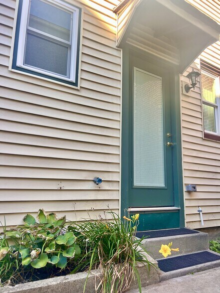sweet garden and flowers greet you - 352 S Main St