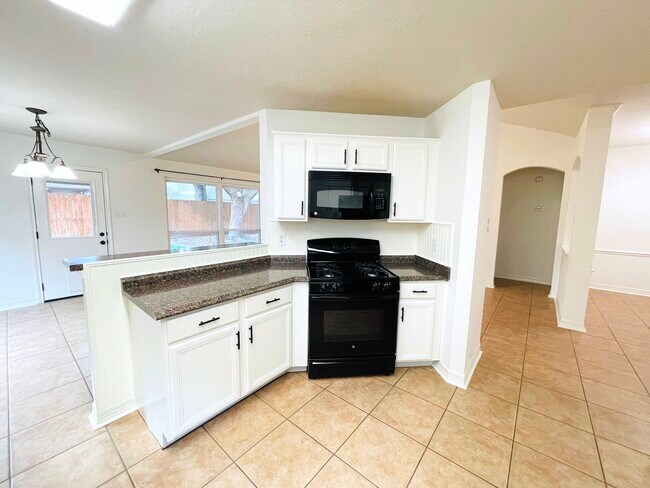 Kitchen opens to the dining and living areas - 14511 Enola Dr