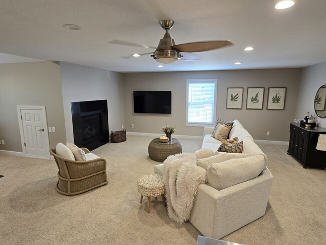 Great Room. Has cozy gas direct vent fireplace and new LG 65" Smart TV. - 5040 Postlewaite Rd