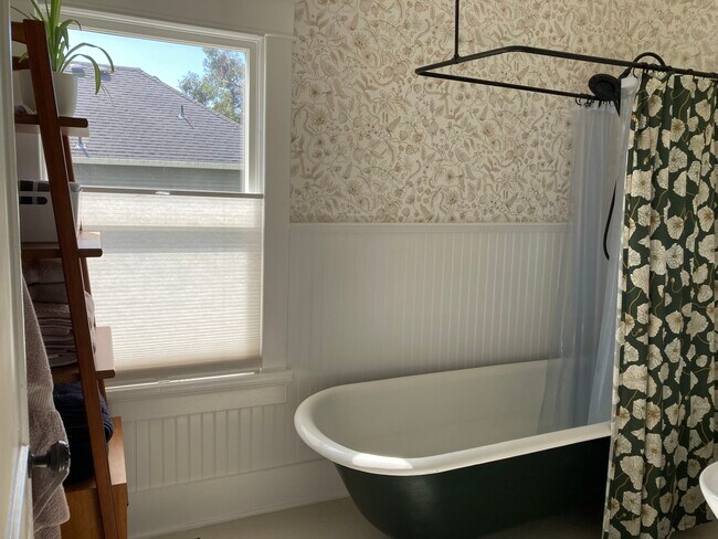 The upstairs bath has a long, deep clawfoot tub and all new finishes. - 1405 NE Buffalo St