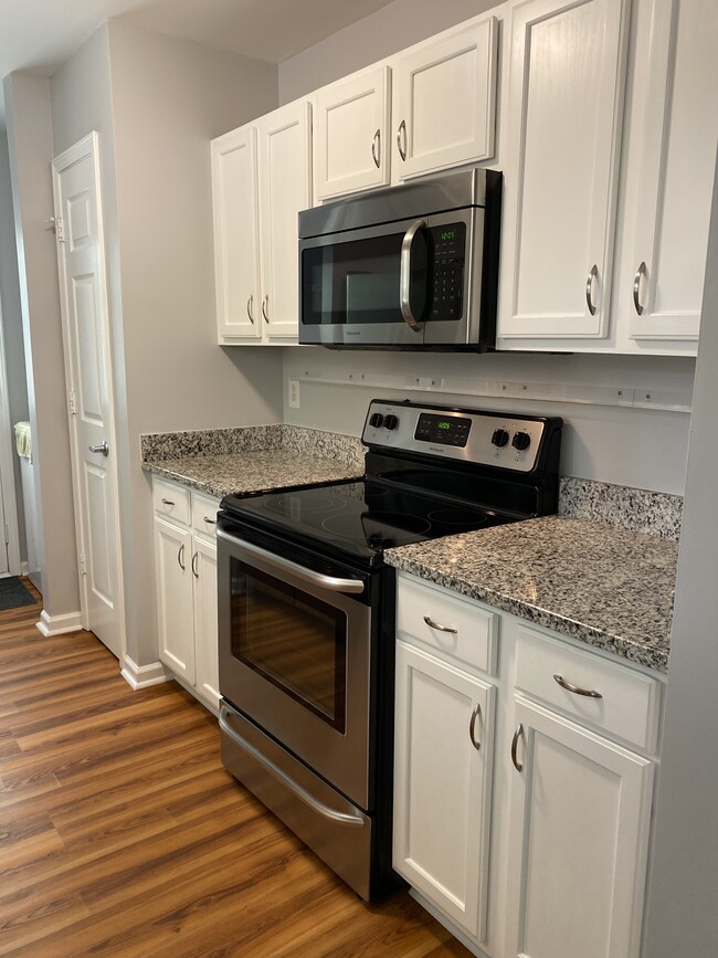 Kitchen and washer dryer located near back door - 1305 Cedar Shoals Drive #500