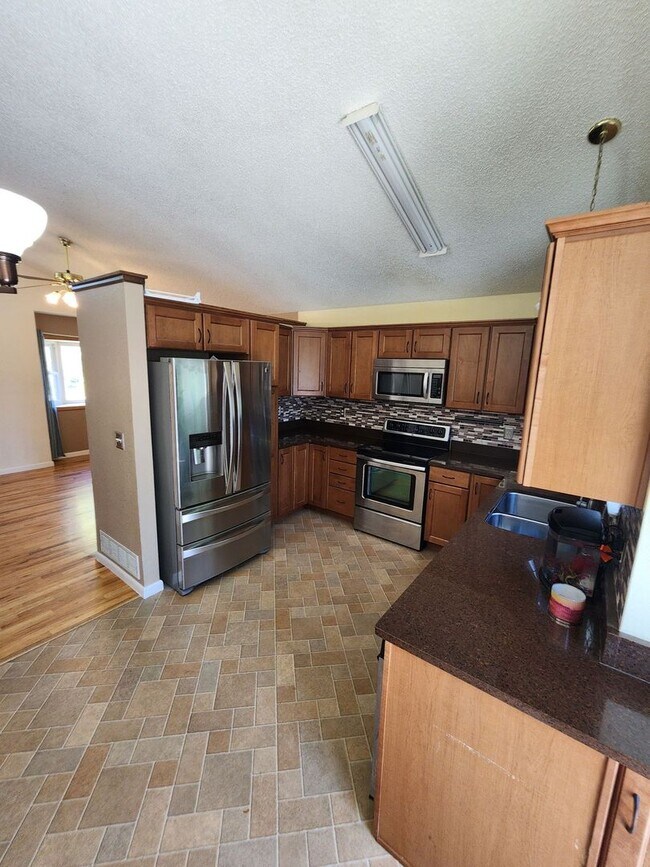 Building Photo - Spacious 4-Bedroom Home with RV Parking in...