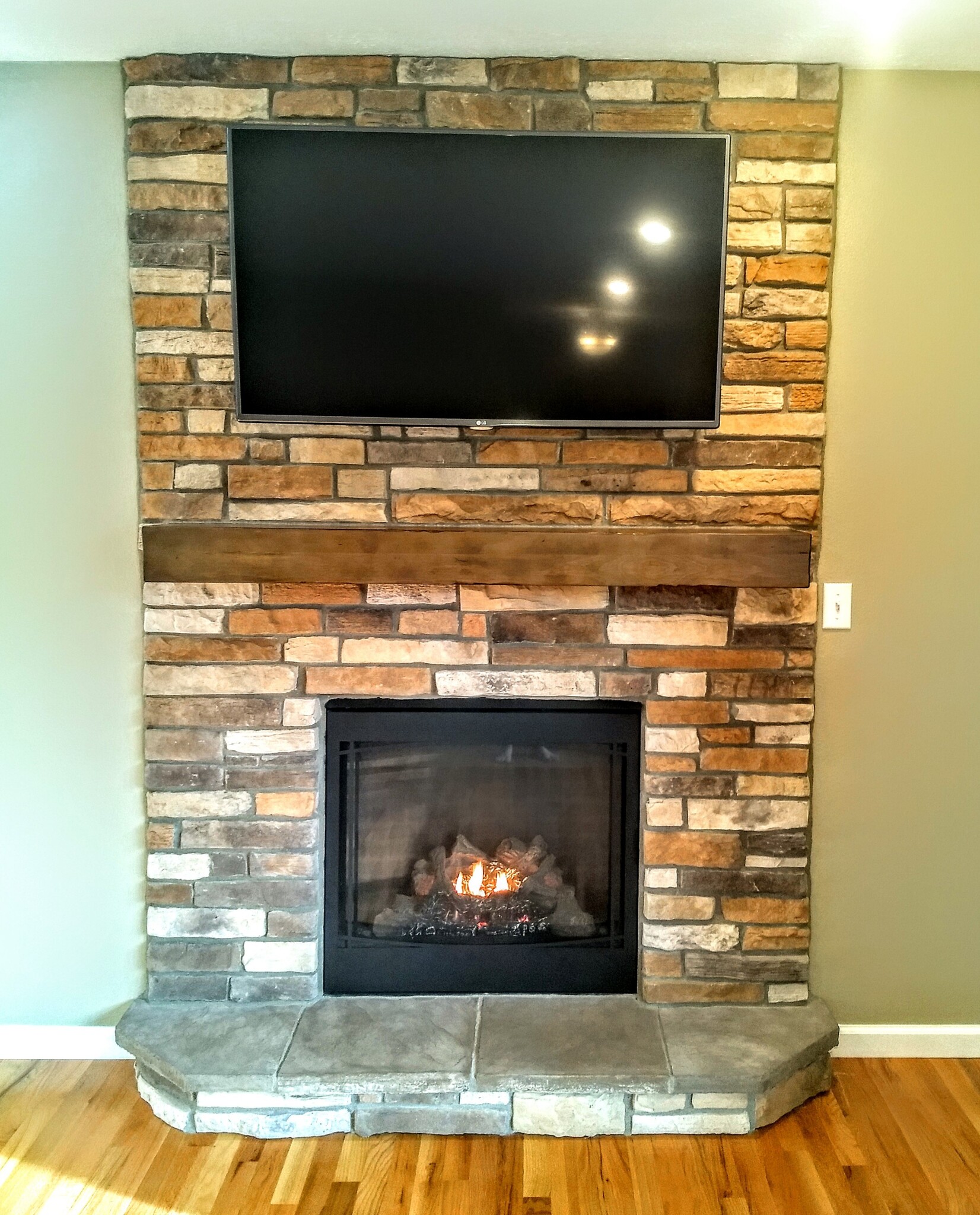 Fireplace with barn beam mantle - 16351 Petro Dr