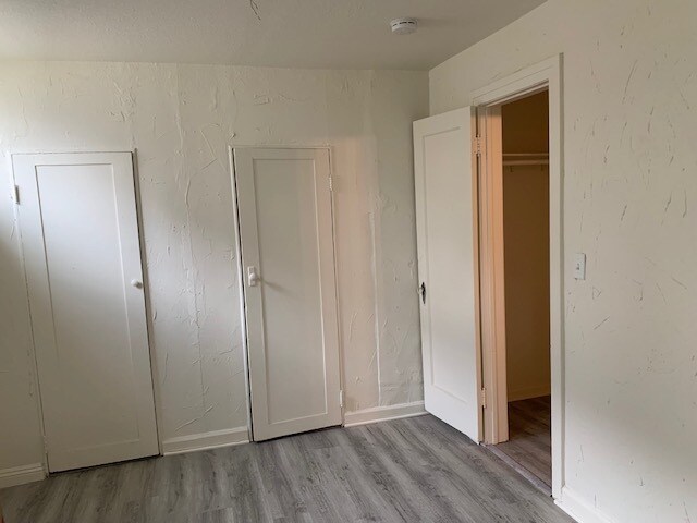 View of the second bedroom's closet (has two doors) and the bedroom door. - 24606 University Ave