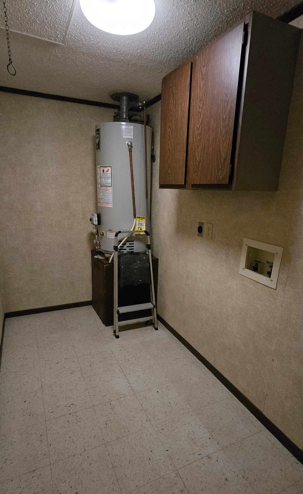 Laundry Room with washer/dryer hookups and access to attic storage. - 27035 Oakmead Dr