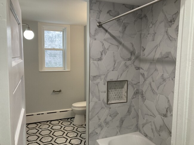 Entering the brand new full bathroom, you're welcomed with lovely tile, handsome fixtures and tons o - 2621 E Somerset St