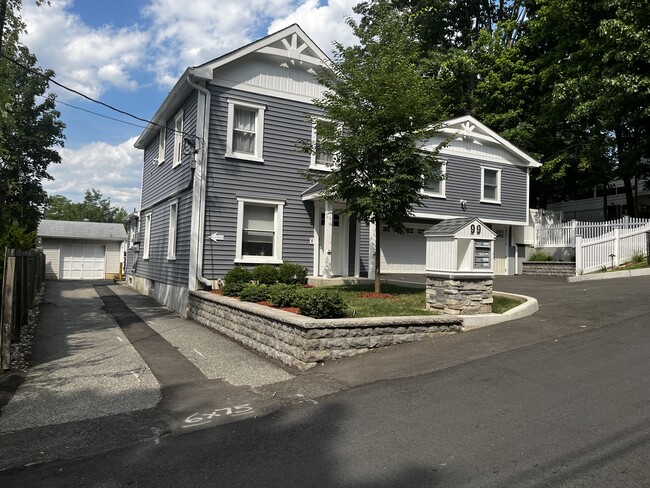 Drive lane with detached garaged included with unit - 99 Roland St