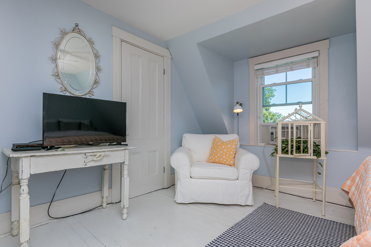 The OCEAN VIEW KING Guest Room with a flatscreen and views from both windows. - 23 Graffam Rd