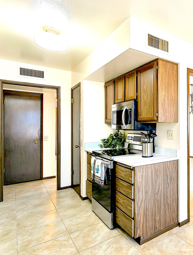 Stainless steel Samsung range and microwave. Full-size pantry for lots of extra storage. - 12414 W Nugget Ct