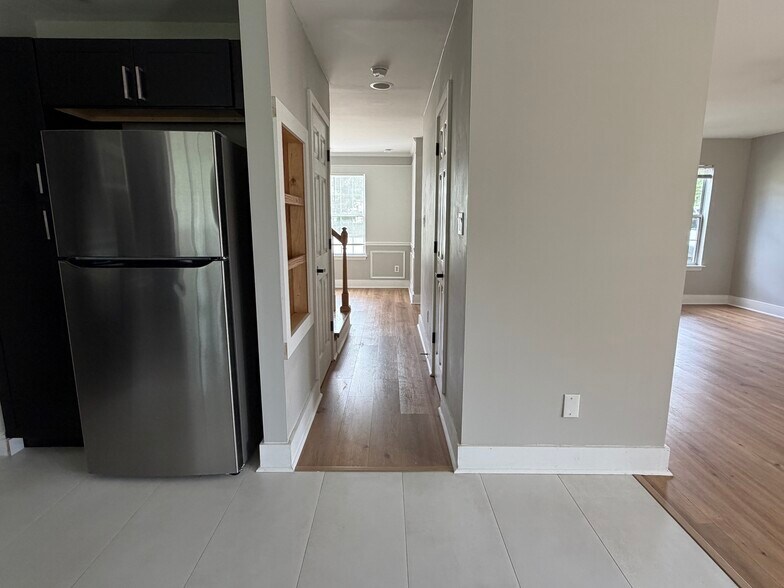 Hall between kitchen and dining room with pantry and half bath - 14204 Lavender Trace Ct