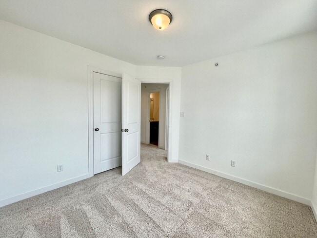 Building Photo - Practically New & Available NOW! Americana Luxury Townhomes! Pet Friendly! Attached Garage! All A...