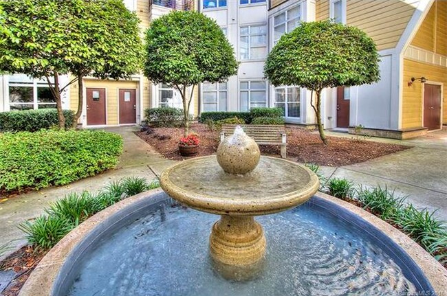 Relax in the secluded courtyard with lots of green space and a water feature. - 2125 Southend Drive