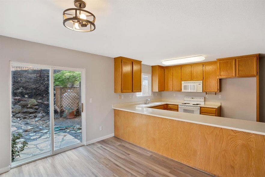 The view of the kitchen from the dining room. - 3038 Courtside Dr