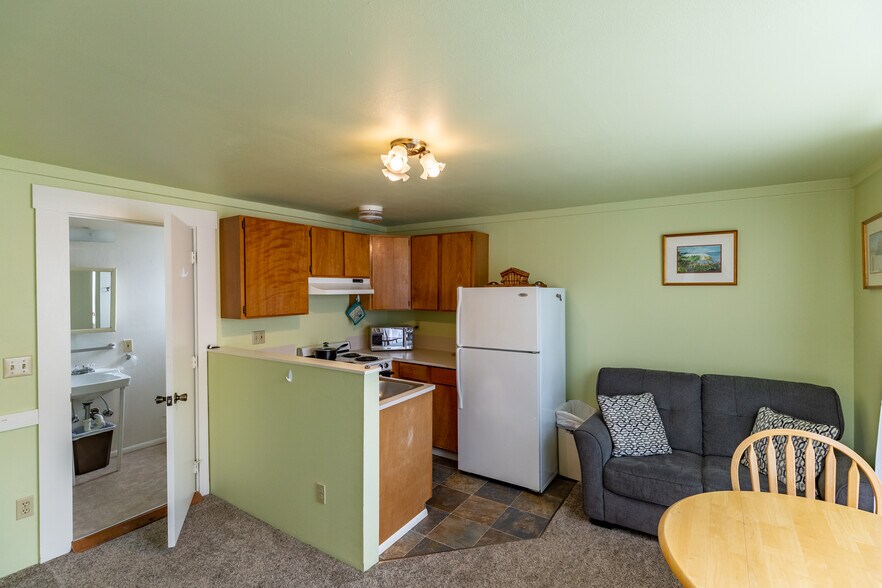 Fully equipped kitchen with microwave, toaster, coffee maker, stove and basic cooking and baking supplies. - 703 Q Ave Apt 4
