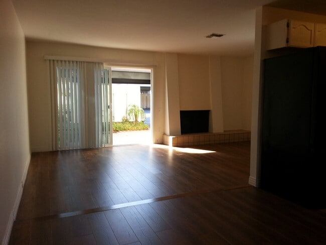 Building Photo - Beautiful Townhome with large fenced back patio, second story balcony, and two covered parking spots