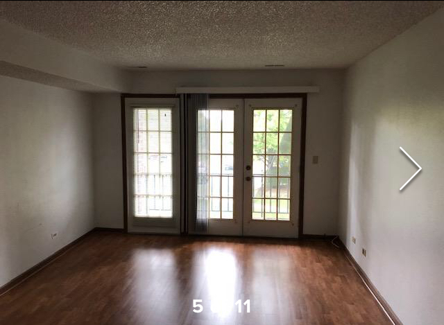 Living room with French doors to the balcony - 520 Biesterfield Rd