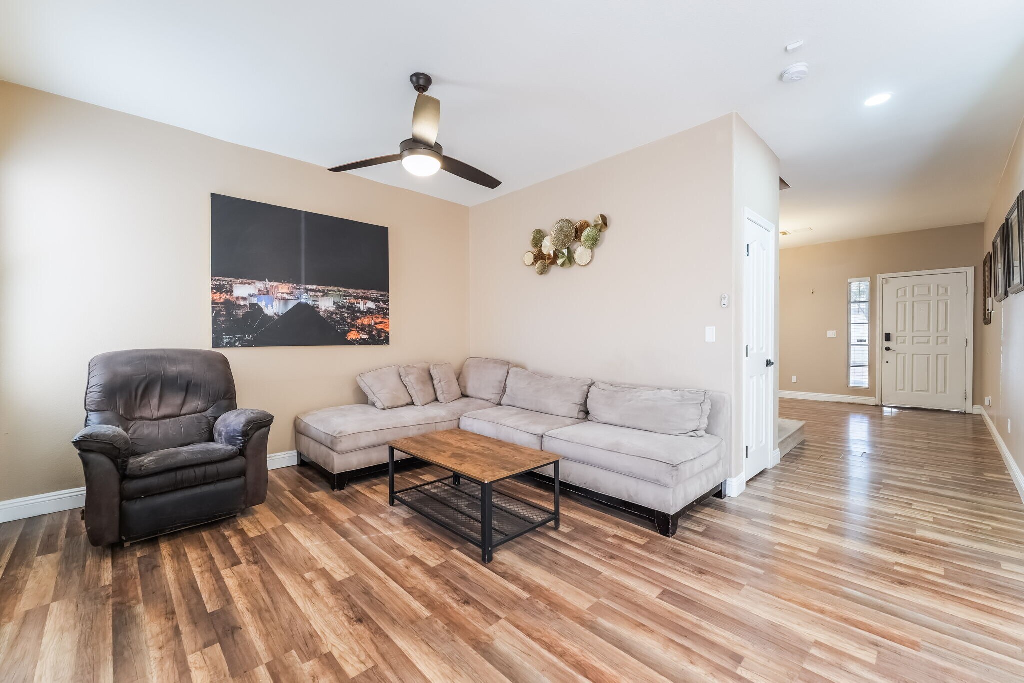 Living room featuring light wood finished floors and ceiling fan - 1179 Antoinette St