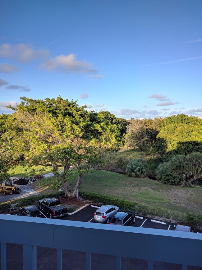 Front balcony with beautiful treelined views. - 198 NW 67th St