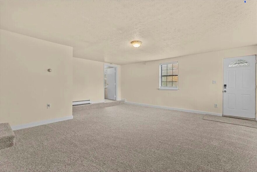 Main living area with fresh wall to wall carpet - 333 Groveland St