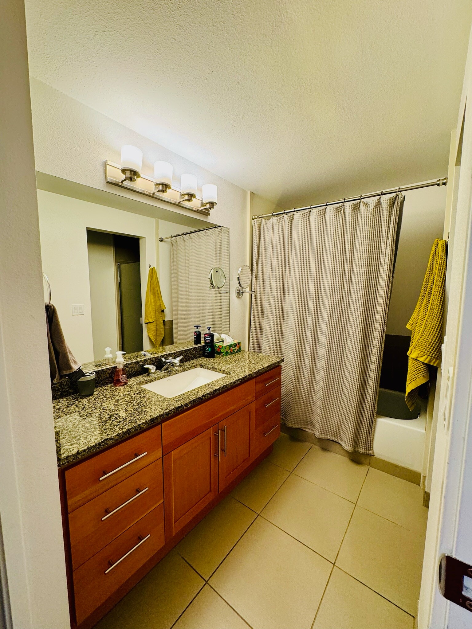 Bright and stylish bathroom with sleek fixtures, ample storage, and elegant finishes. - 2145 Dexter Ave N