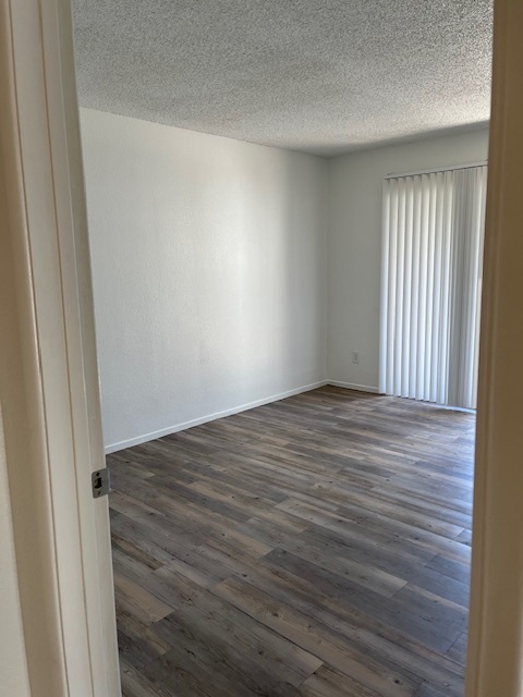 Empty bedroom (popcorn ceilings have been removed) - 6480 N 82nd St