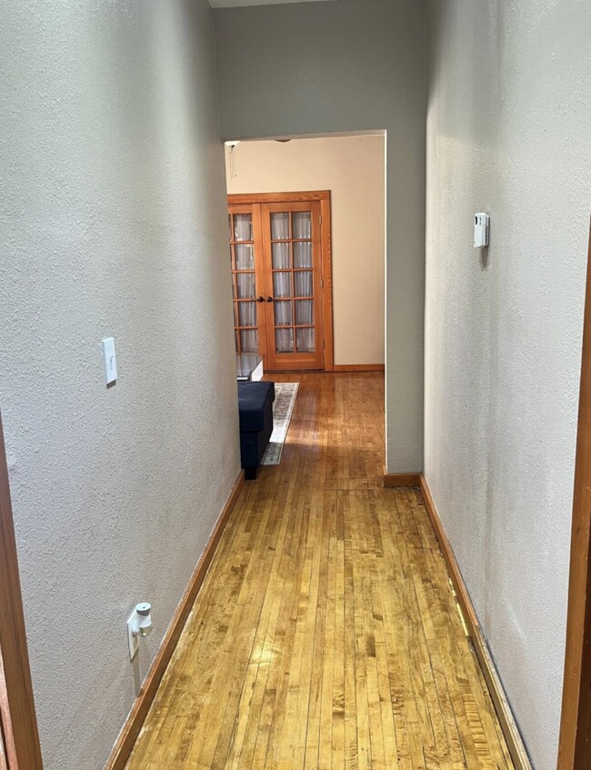 Back in the unit, this is the hallway from the living room to the kitchen and bedrooms. - 3517 19th Ave S