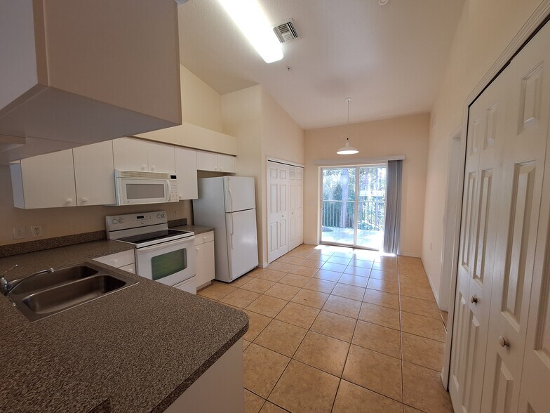 Kitchen facing the lanai, with space for small dining table. - 25727 Lake Amelia Way