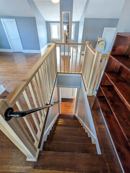 Stairs from 3rd bonus room, industrial handrail - 3607 Franklin Ave