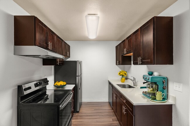 Step into a stylish and functional modern kitchen designed for culinary creativity. - University Crossing Apartments