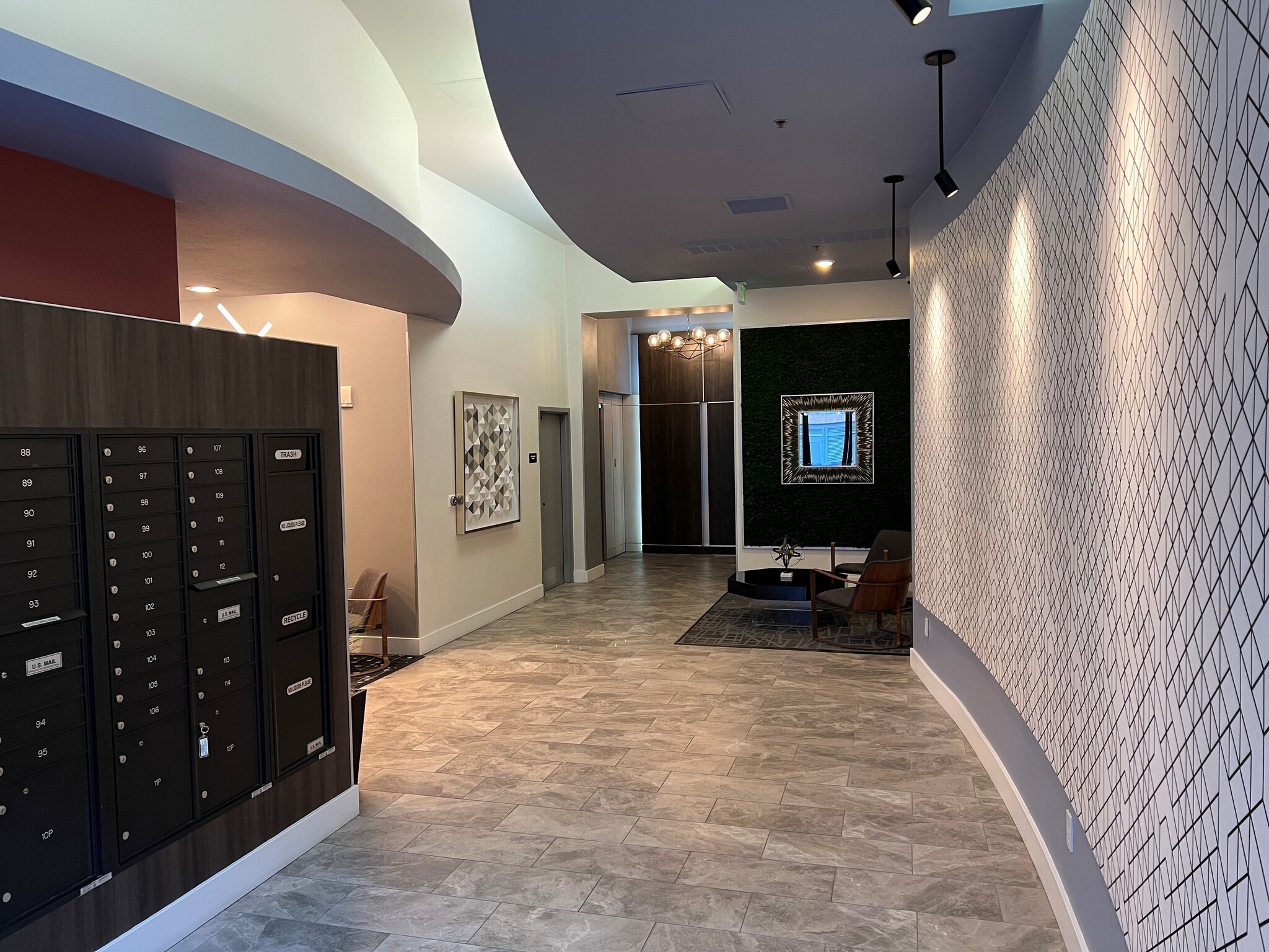 Welcoming lobby with two seating areas and modern decor. - 427 9th Ave