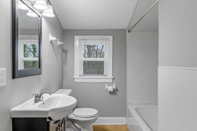 Building Photo - Brick home, Two Story, Hardwoods, DR, 2 Sun Rooms, FP, Carport!.