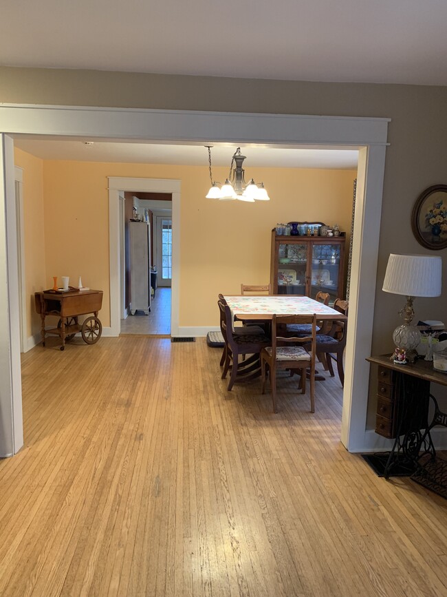 Living room looking into the dining room from the front door. - 704 W Cherokee Dr