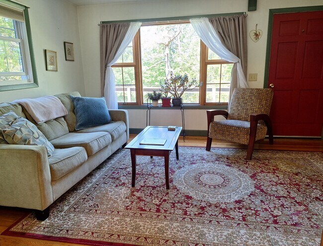 Living room, sun sets through picture window - 490 Cross Point Rd