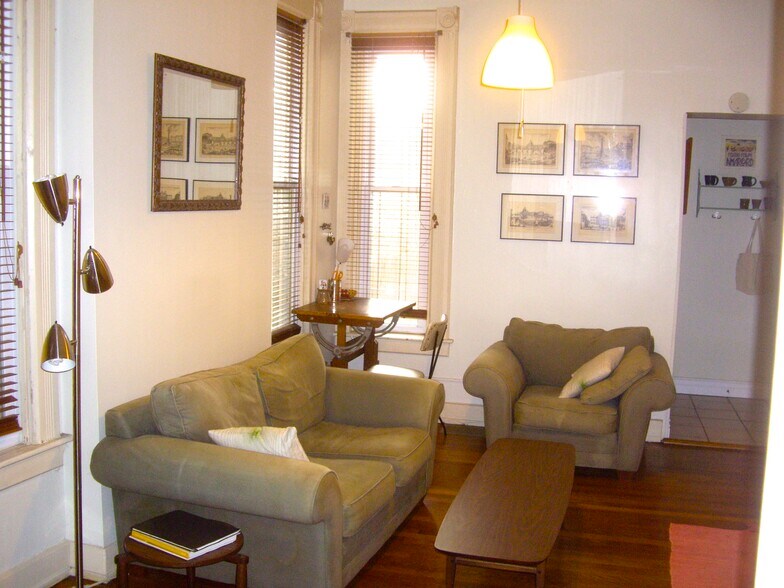Living room with passageway to back bath and kitchen. - 22 Lyon St