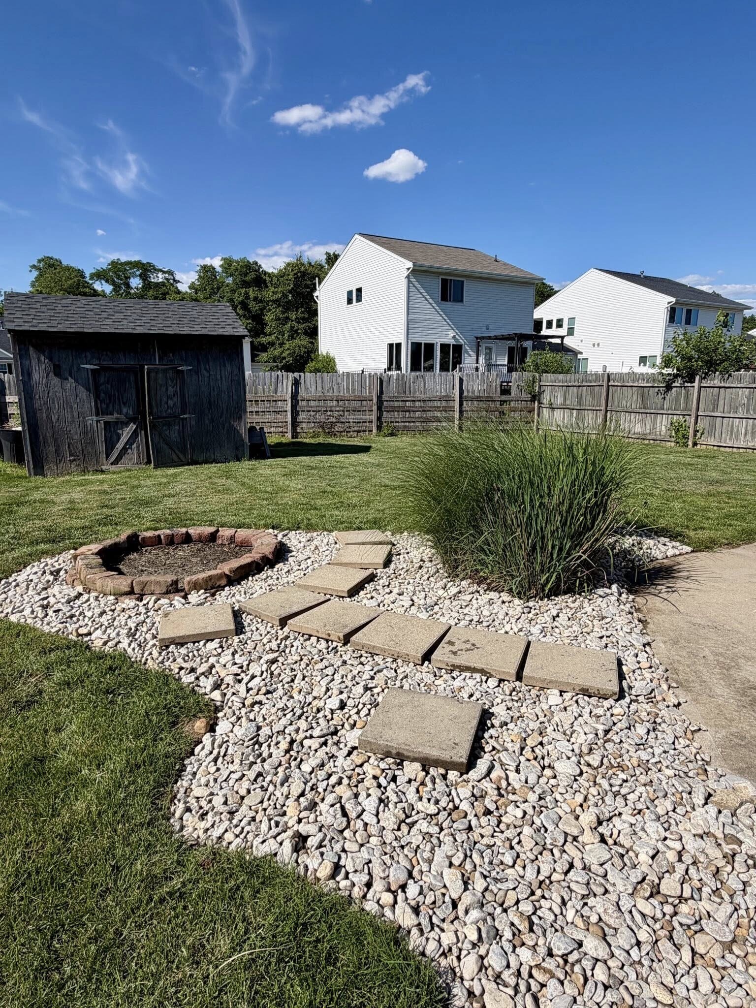 Fenced back yard with large concrete patio and fire pit - 1200 Bugle Bluff Ct